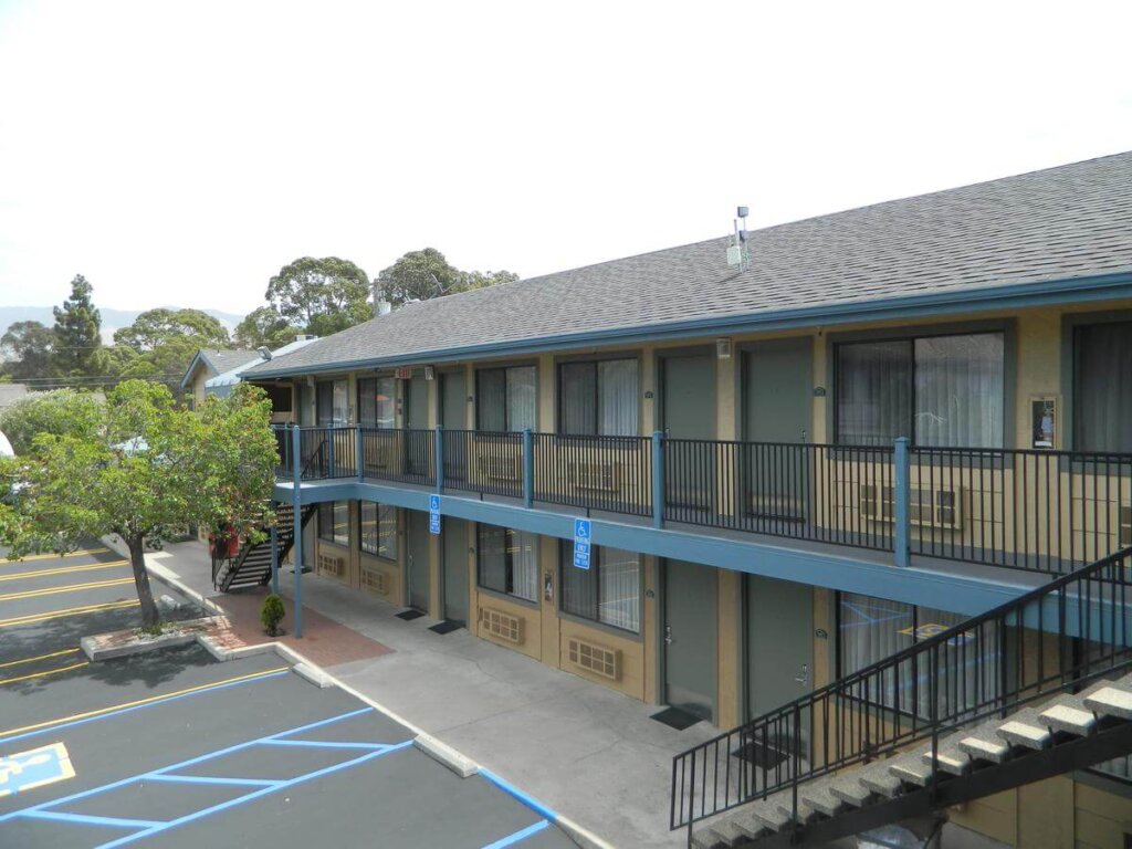 2-story SLO INN exterior balcony and parking lot in San Luis Obispo.