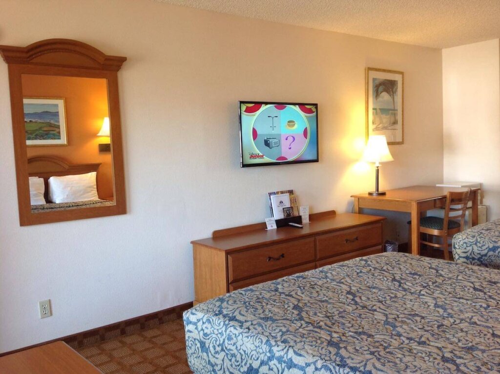 2 beds and a TV in a room of the SLO INN in San Luis Obispo.