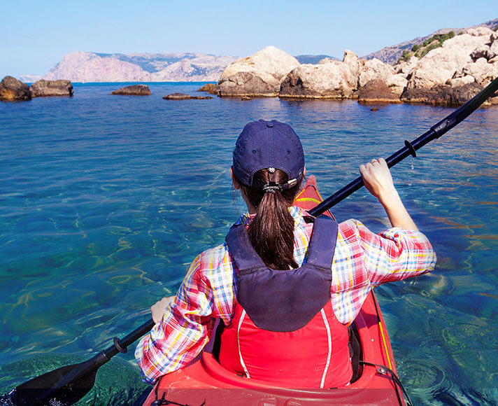 Woman kayaking in the ocean