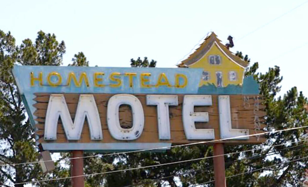 Welcome sign for Homestead Motel