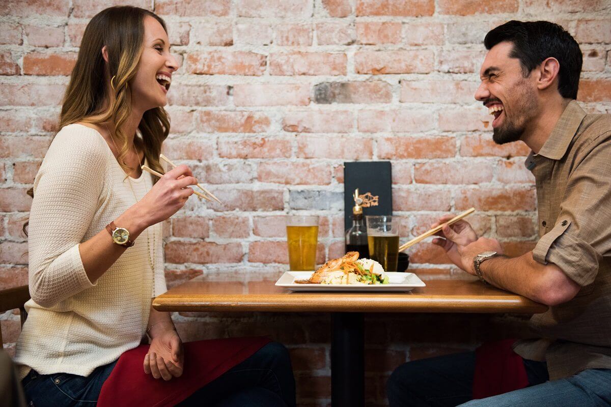 Couple Laughing at Naked Fish