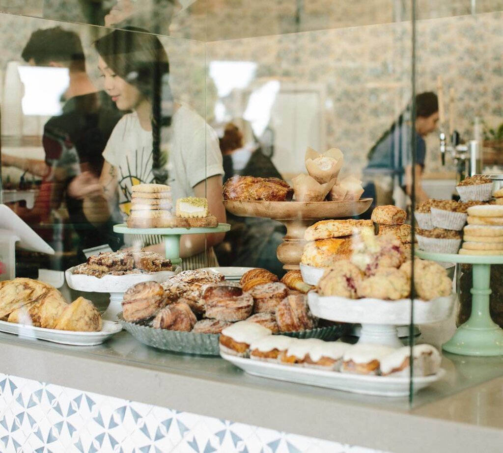 Scout Coffee's pastries behind a pane of glass.