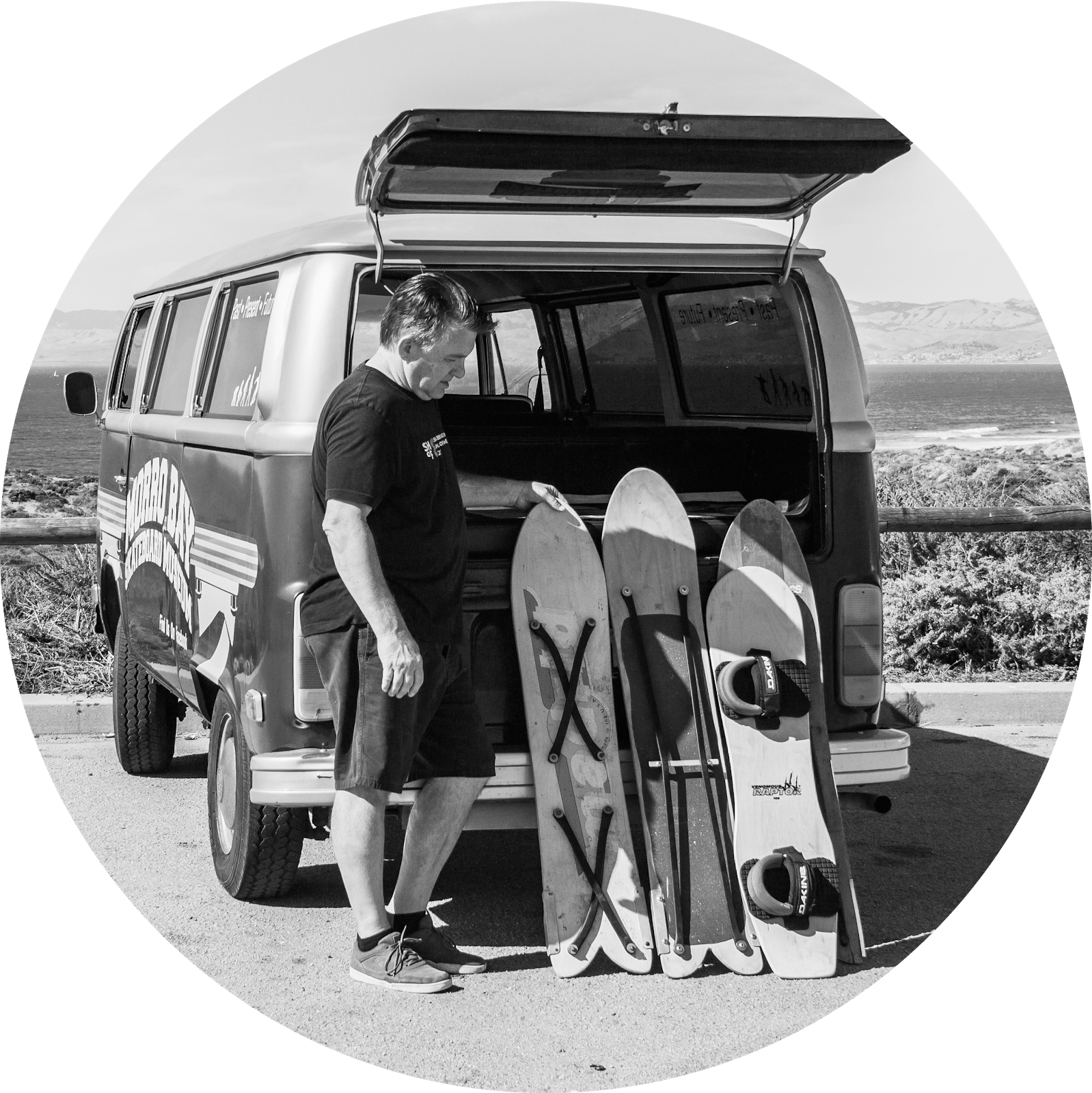Sandboard pioneer Jack Smith in front of his van with three boards.