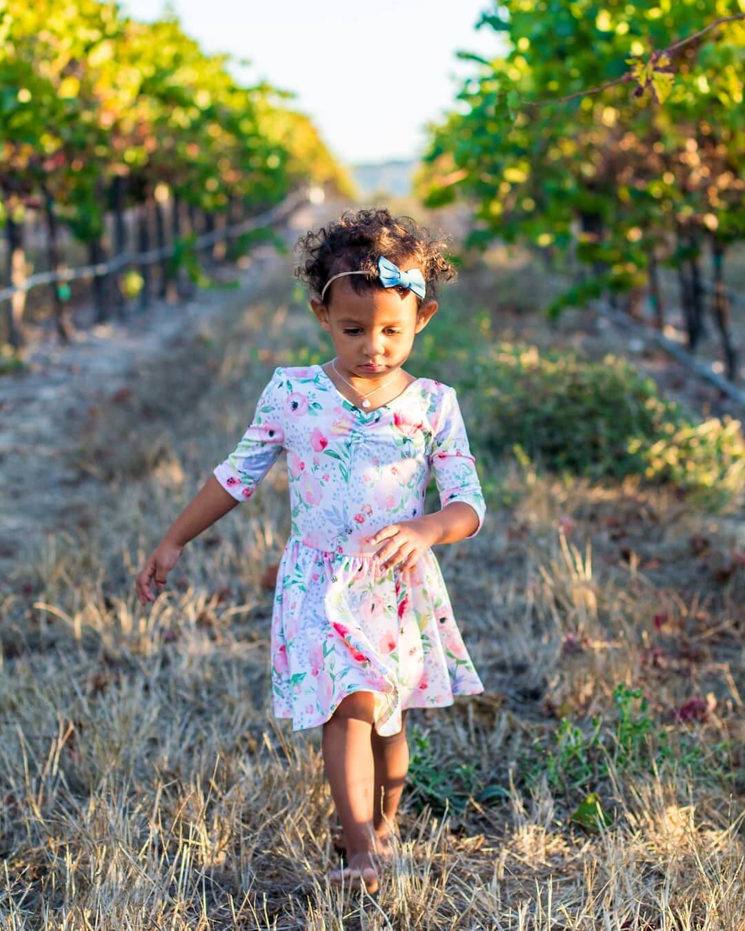 Little girl walking barefoot through the Tolosa Vineyards