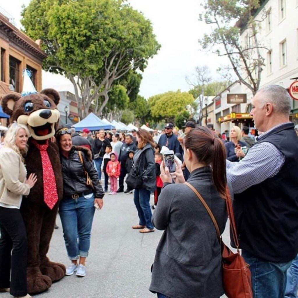 Posing with the Bear Mascot at the Downtown SLO Farmers' Market.