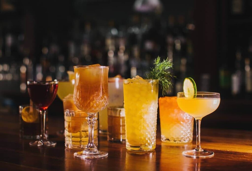 Assorted cocktails on the wood bar top at Sidecar SLO