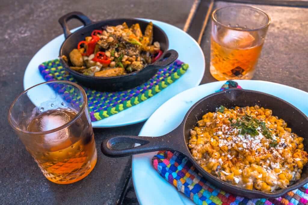 2 skillet plates and two cocktails in rocks glasses from 1865 Crafthouse in San Luis Obispo