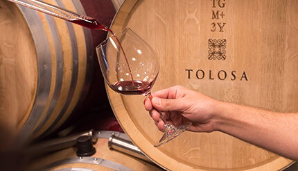 tolosa wine barrel pouring wine into a glass