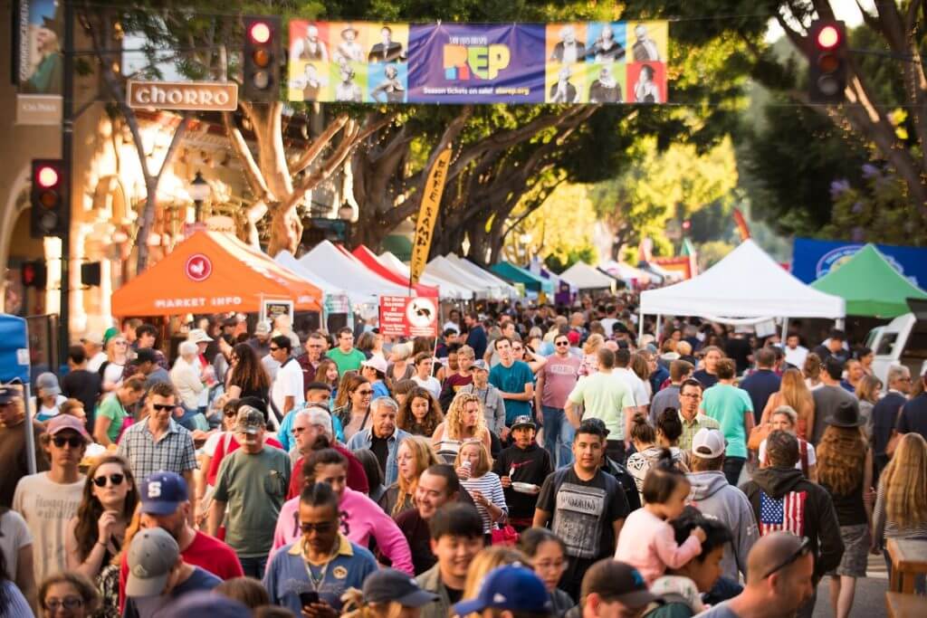 people walking down SLO's farmer market