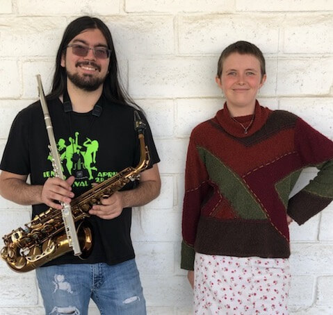 The Adam and Emily Jazz Duo, smiling with saxophone in hand.