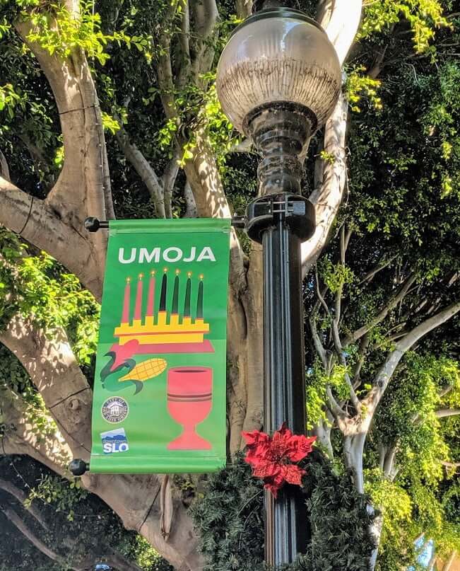 A street light banner in San Luis Obispo celebrating Kwanzaa.
