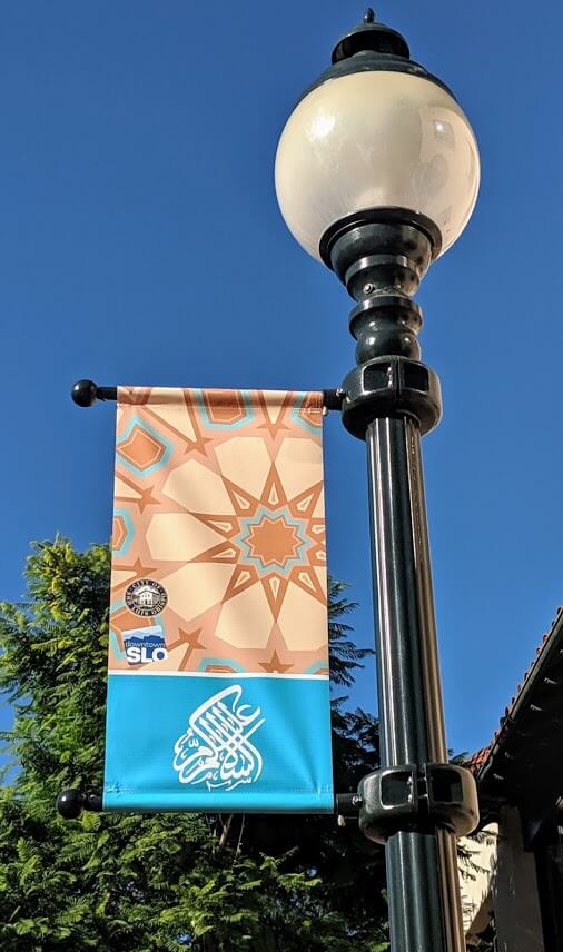 Downtown San Luis Obispo street light with a banner celebrating Assalamu Alaikum.