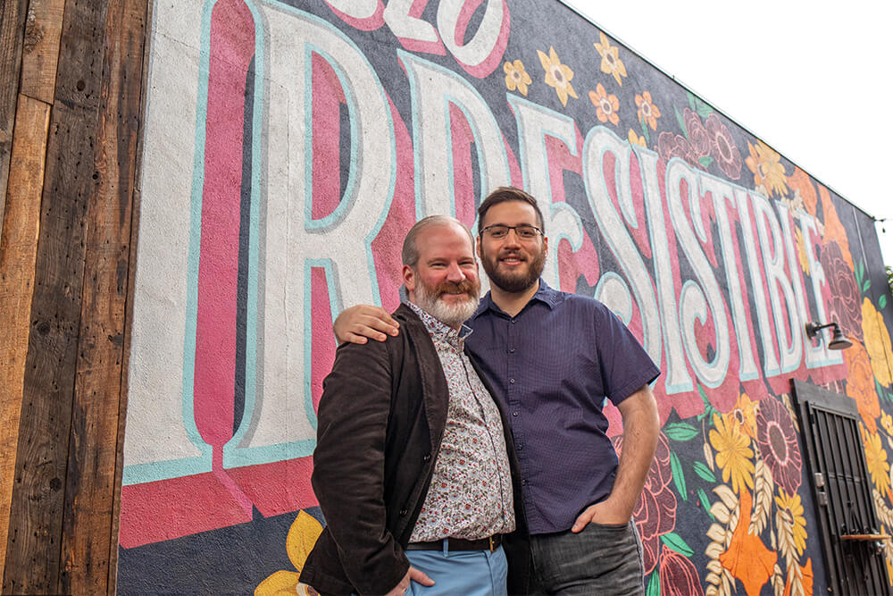 Two men pose with the SLO Irresistible Mural