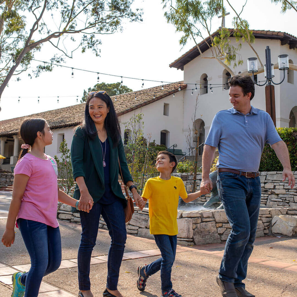 family strolls through mission plaza