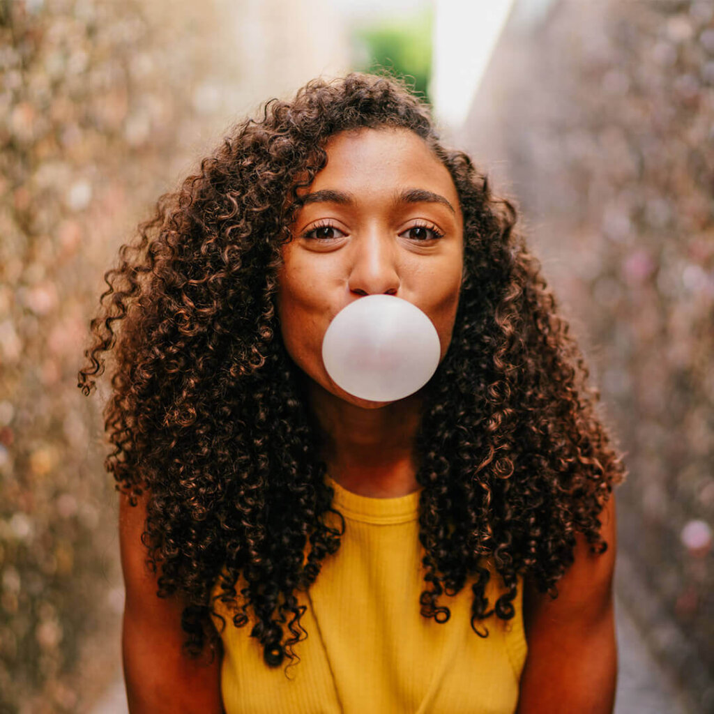 Young woman blows bubblegum in Bubblegum Alley