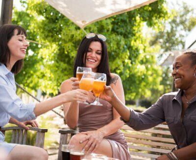 friends gather around a table for some sunshine and drinks in san luis obispo