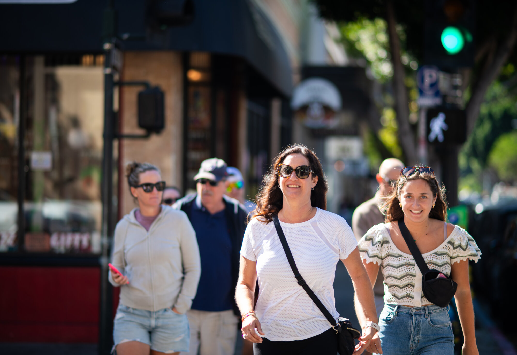 People-smiling-walking-across-the-street-on-higuera-street