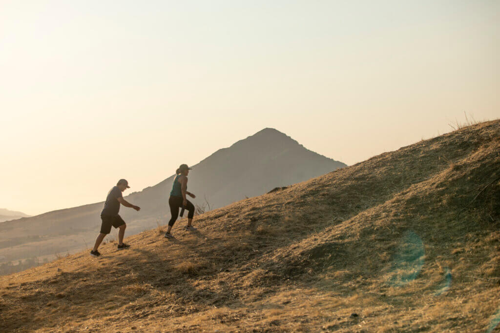couple-is-hiking-up-mountain
