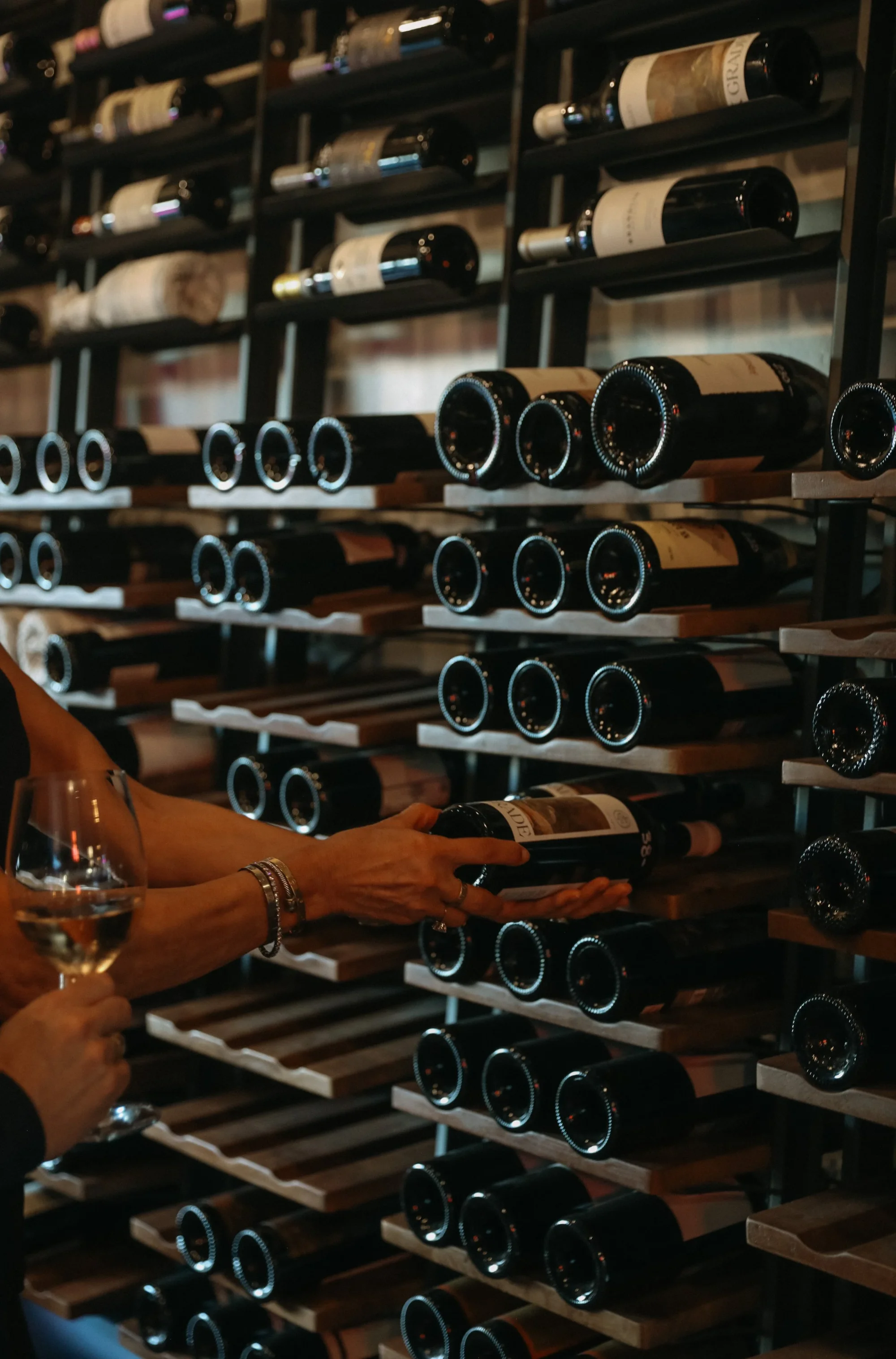 someone pulling wine bottle out