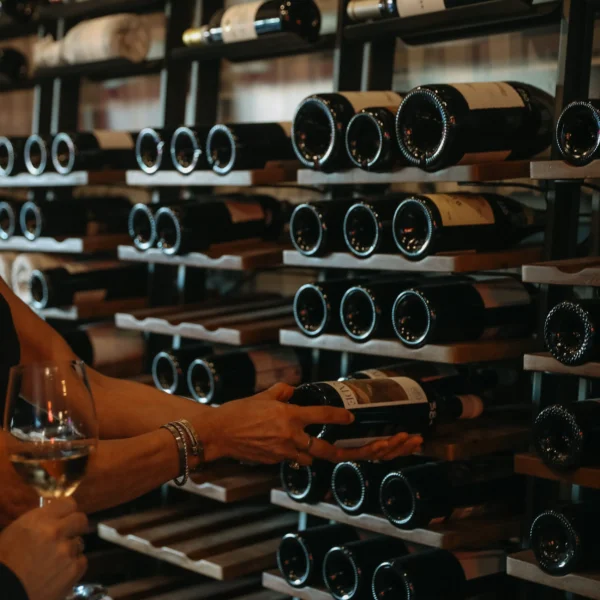 someone pulling wine bottle out