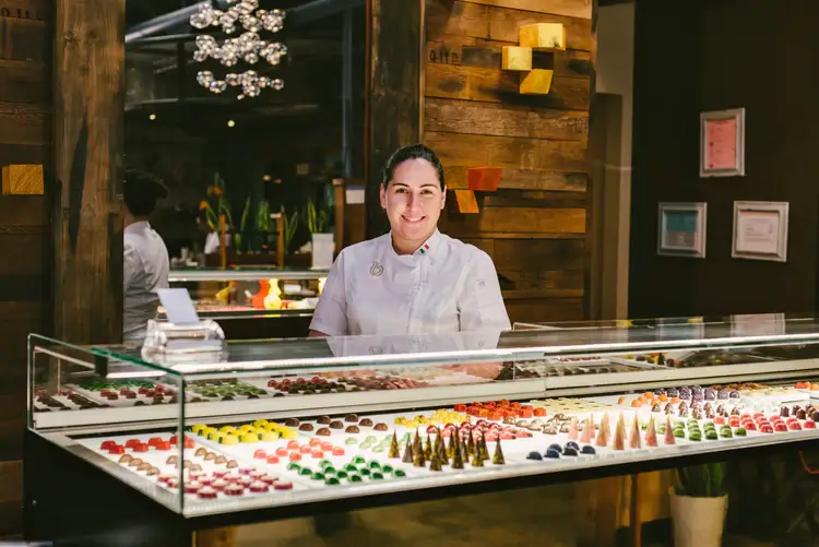 Breda owner standing by chocolates