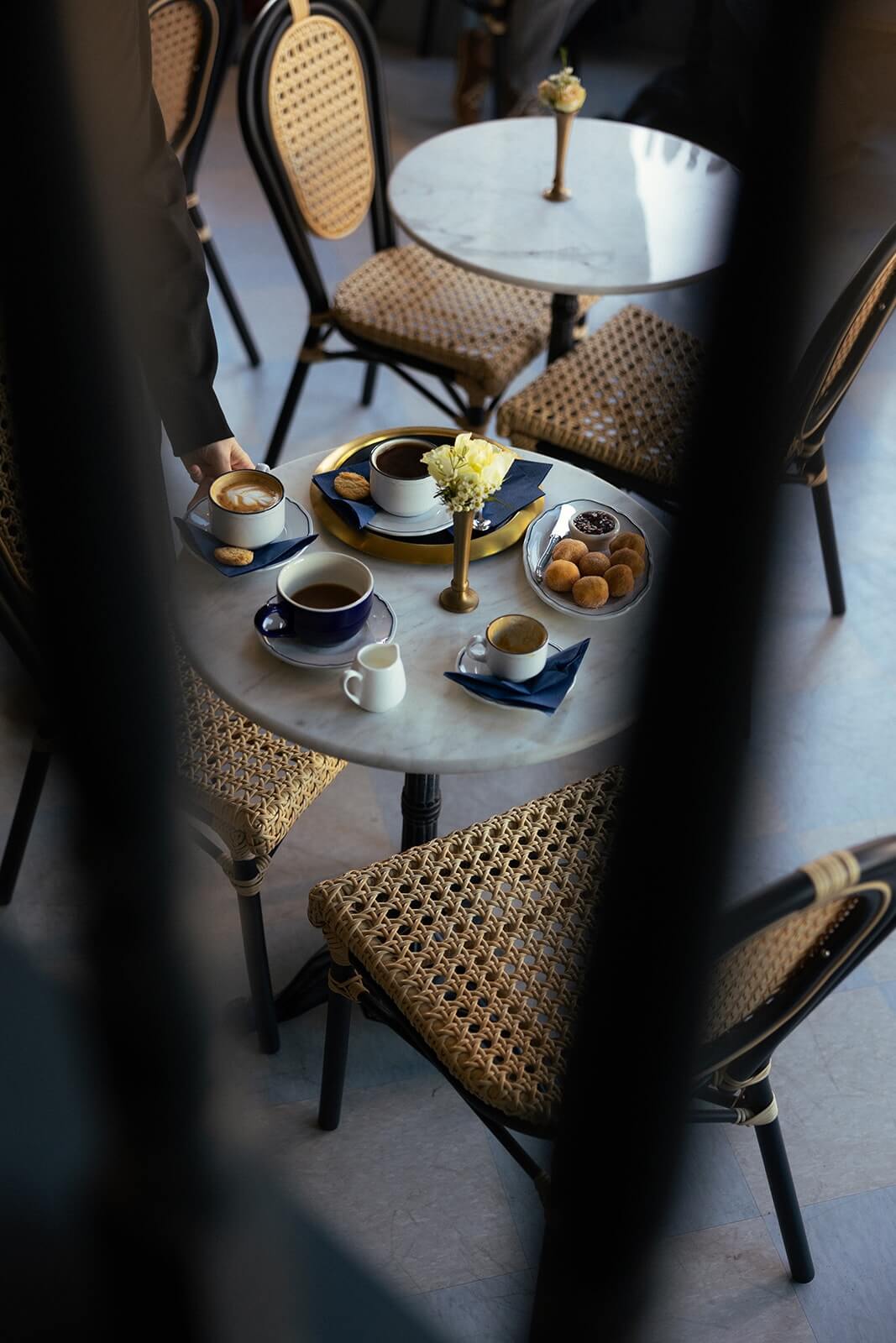 abstract photo of Anderson Social table with coffee and pastries