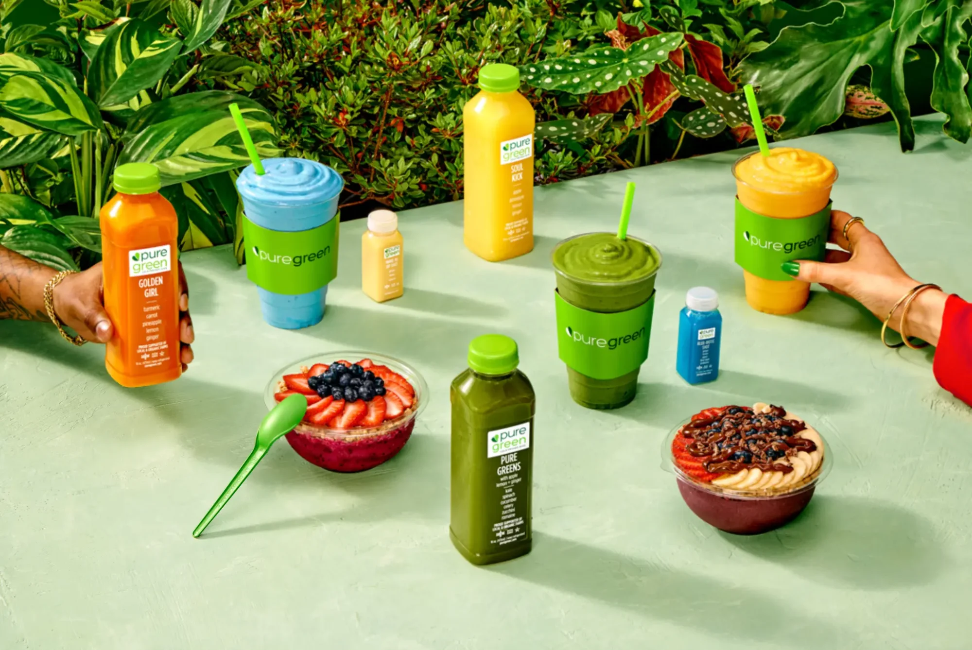 pure green products with people holding them