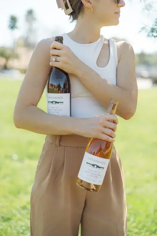 woman-holding-two-wine-bottles